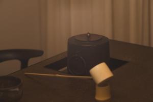 a candle sitting on a table with a paper roll at new tradition hotel kanazawa in Kanazawa +24 photos