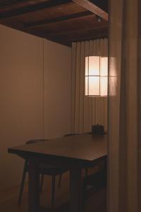 a dining room table with a light hanging over it at new tradition hotel kanazawa in Kanazawa