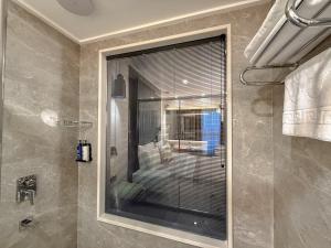 a bathroom with a shower with a glass window at Dedeman Adana in Adana +71 photos