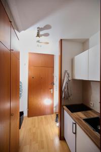 a kitchen with white cabinets and a wooden door at Asmus Unterkunft in Immenstadt im Allgäu +11 photos
