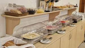a buffet with many different types of food on a counter at Efrosini Hotel Apartments & Studios in Paralia Panteleimonos +67 photos