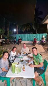 a group of people sitting at a table eating at VAL Homestay in Siquijor