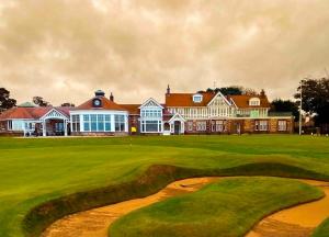 a golf course with a large house in the background at Cozy 3 bedroom caravan near Edinburgh, 61 StAndrews at Seton Sands Holiday Village in Port Seton