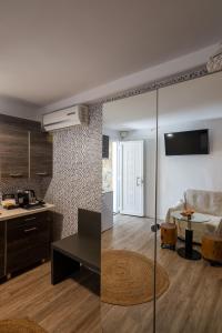 a kitchen and a living room with a table at Double M Adults Only in Ano Mera
