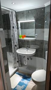 a bathroom with a sink and a toilet and a mirror at Park Hotel in Hamm +28 photos