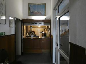 a hallway with a reception sign in a building at Park Hotel in Hamm