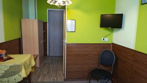 a room with a table and a television on the wall at Park Hotel in Hamm