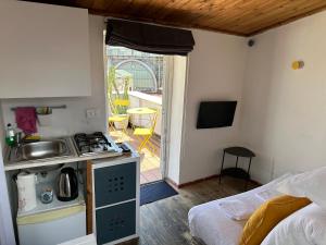 a small kitchen with a stove and a balcony at Tiny Nest Over Naples, Private Panoramic Terrace in Naples