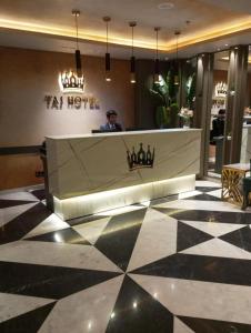 a woman sitting at a counter in a hotel lobby at Taj Signature Hotel - F7 Markaz Islamabad in Islamabad +21 photos