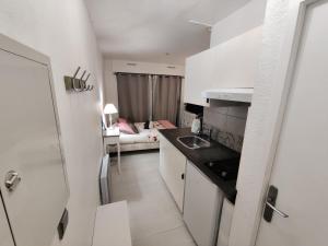 a small kitchen with a sink and a room at Studio idéal cure ou séjour escapade in Balaruc-les-Bains