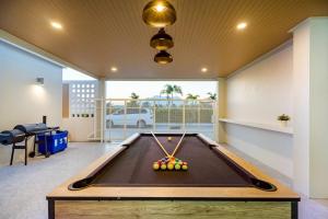 a pool table in the middle of a room at You Baan Pool Villa Cha-am in Ban Bo Prakhon