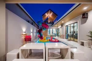 a childrens play room with a slide in a house at You Baan Pool Villa Cha-am in Ban Bo Prakhon