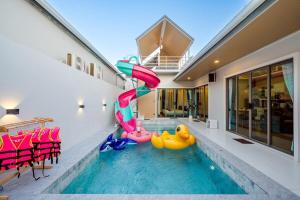 a swimming pool with two rubber ducks in a house at You Baan Pool Villa Cha-am in Ban Bo Prakhon