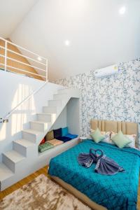 a bedroom with a bed next to a staircase at You Baan Pool Villa Cha-am in Ban Bo Prakhon +75 photos