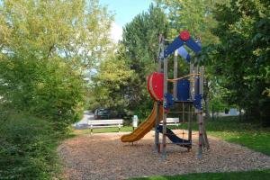 a playground with a slide in a park at DURBUY Residence-A202- in Durbuy