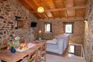 a living room with a table and a couch at Armonia Sun Tower in Exochori