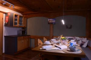 a kitchen with a wooden table in a room at Beim Patzelt - Ferienhaus in Nesselwang in Nesselwang
