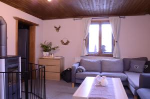 a living room with a couch and a table at Beim Patzelt - Ferienhaus in Nesselwang in Nesselwang +24 photos
