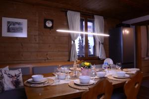 a wooden table with plates and glasses on it at Beim Patzelt - Ferienhaus in Nesselwang in Nesselwang