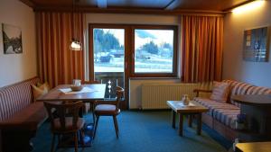 a living room with a couch and a table at Landhaus Schmitte in Biberwier