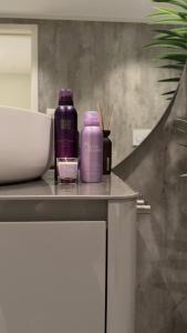 two purple bottles sitting on top of a counter at The View XL in Senja +1 photo