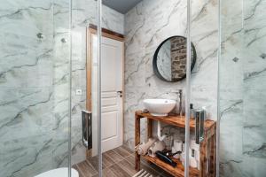 a bathroom with a sink and a glass shower at Villa Riverwood  +62 photos