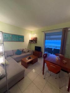 a living room with a couch and a table at Glyfada Menigos Apartment 21 in Glyfada