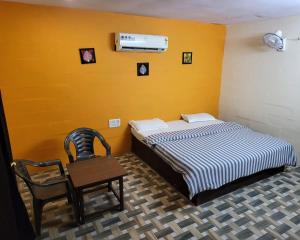 a bedroom with a bed and a table and chairs at Pushkar Prime Resort in Pushkar
