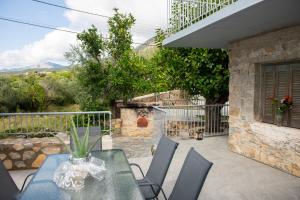 a patio with a table and chairs on a balcony at Armonia Sun Tower in Exochori