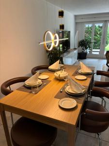 a wooden table with chairs and a dining room at Garden Park Apartment in Interlaken +22 photos