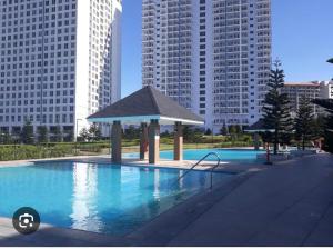 a swimming pool with a gazebo in a city at The Wind Escape Netflix-Ready Staycation for 4 in Tagaytay