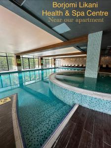 a swimming pool in a building with the words bronowment library health and spa centre at Luxury Residence Likani in Borjomi