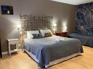 a bedroom with a large bed in a room at Le Manoir des Sables - Hébergement familial grand confort in Berthegon +31 photos