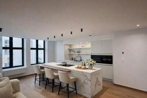 a kitchen with a large island in the middle of a room at Burgschelde 63 in Oudenaarde