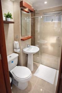 a bathroom with a toilet and a sink and a shower at Hotel VIYAJE in Funza
