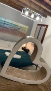a metal sculpture on a table in a room at Frida Apartment in Chioggia