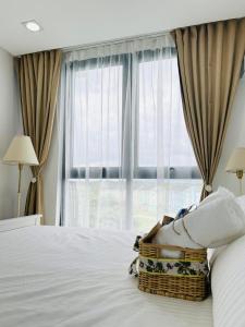 a woman laying on a bed in front of a window at Unit 509 - One Pontefino Tower in Batangas City