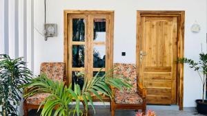 a pair of chairs sitting in front of a door at Breezy Resort in Arugam Bay