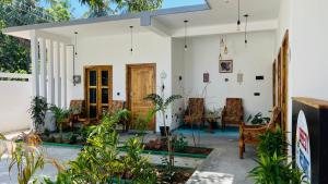 a house with a lot of plants in the yard at Breezy Resort in Arugam Bay