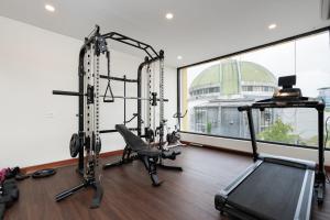 a gym with two tread machines and a treadmill at Sans Hotel Elrose Place in Samarinda