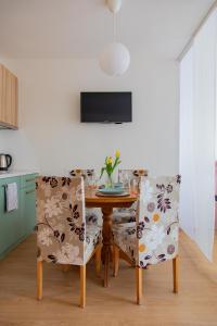 a dining room with a table and two chairs at Студио 8 Уютна Почивка in Hisarya