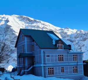 a house in front of a snow covered mountain at Beyond Rohtang in Tāndi +59 photos