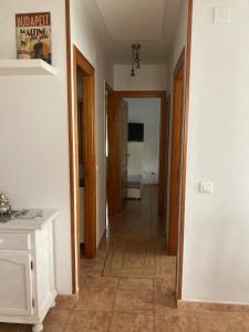 a hallway with a hallway leading to a room at Liencres Apartment in Liencres