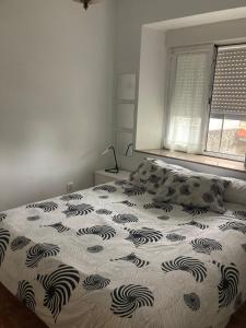 a bedroom with a bed and a window at Liencres Apartment in Liencres