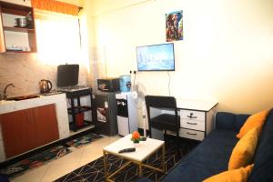 a living room with a couch and a table at PALISADES homes in Voi +1 photo