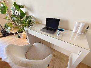 a white desk with a laptop and a chair at DiDi Calm 105 in Tokushima