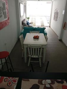 a dining room with a table and chairs and a room with a window at Pousada Hostel Brasil Gru in Guarulhos