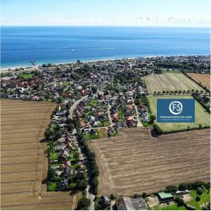 an aerial view of a city with houses and the ocean at Haus Schwalbennest in Dahme