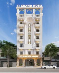 a white building with a sign on it at Si Grand Ninh Binh Hotel in Ninh Binh