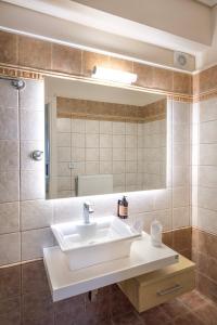 a bathroom with a sink and a mirror at Lake Kremasta Hotel in Neokhórion +39 photos